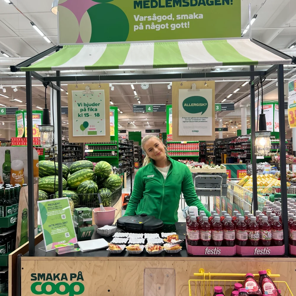 Event staff at Coop offering tastings during an in-store demo on Member Day.